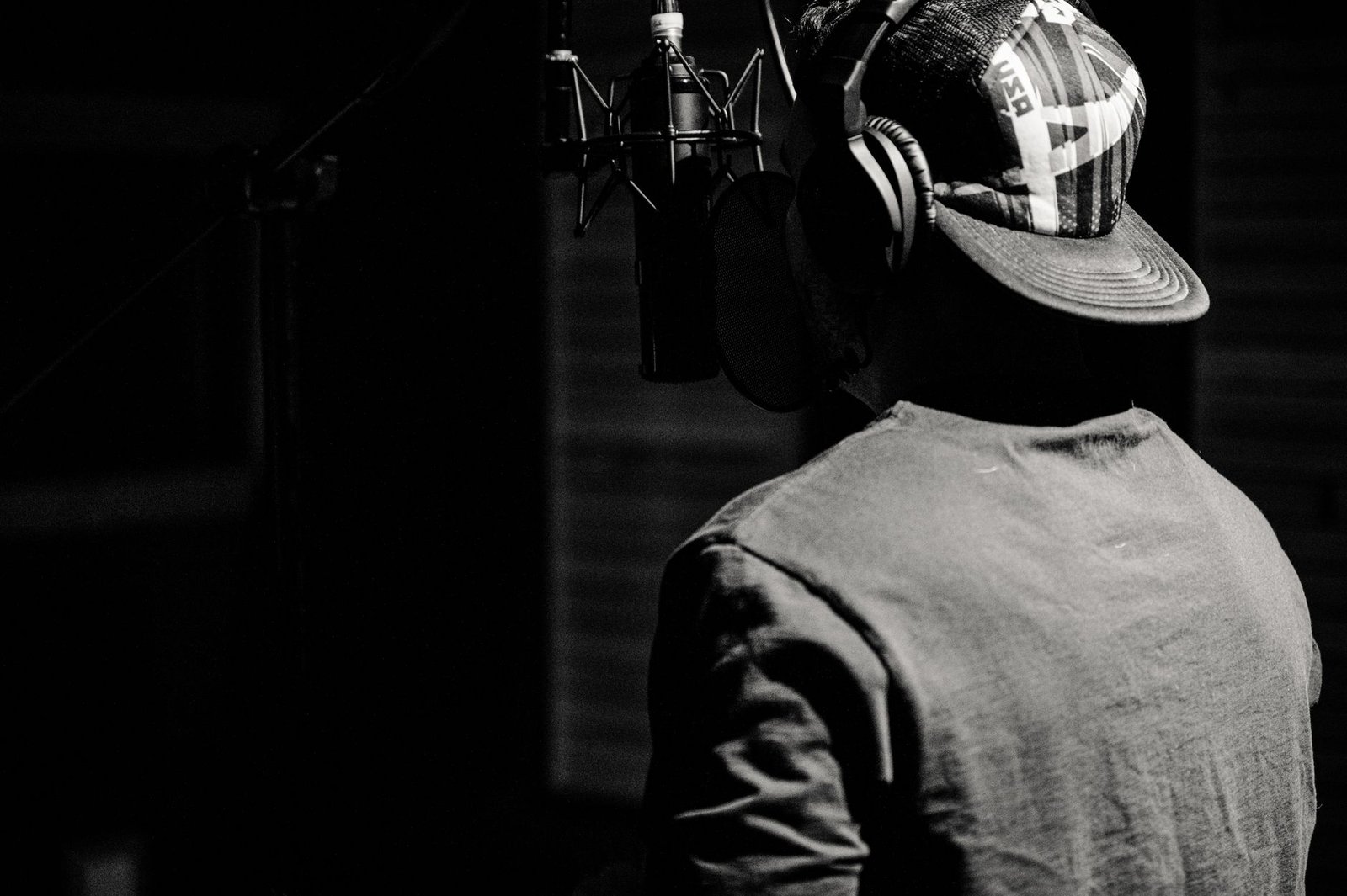 Narrateur au casque devant un microphone en cabine d'enregistrement